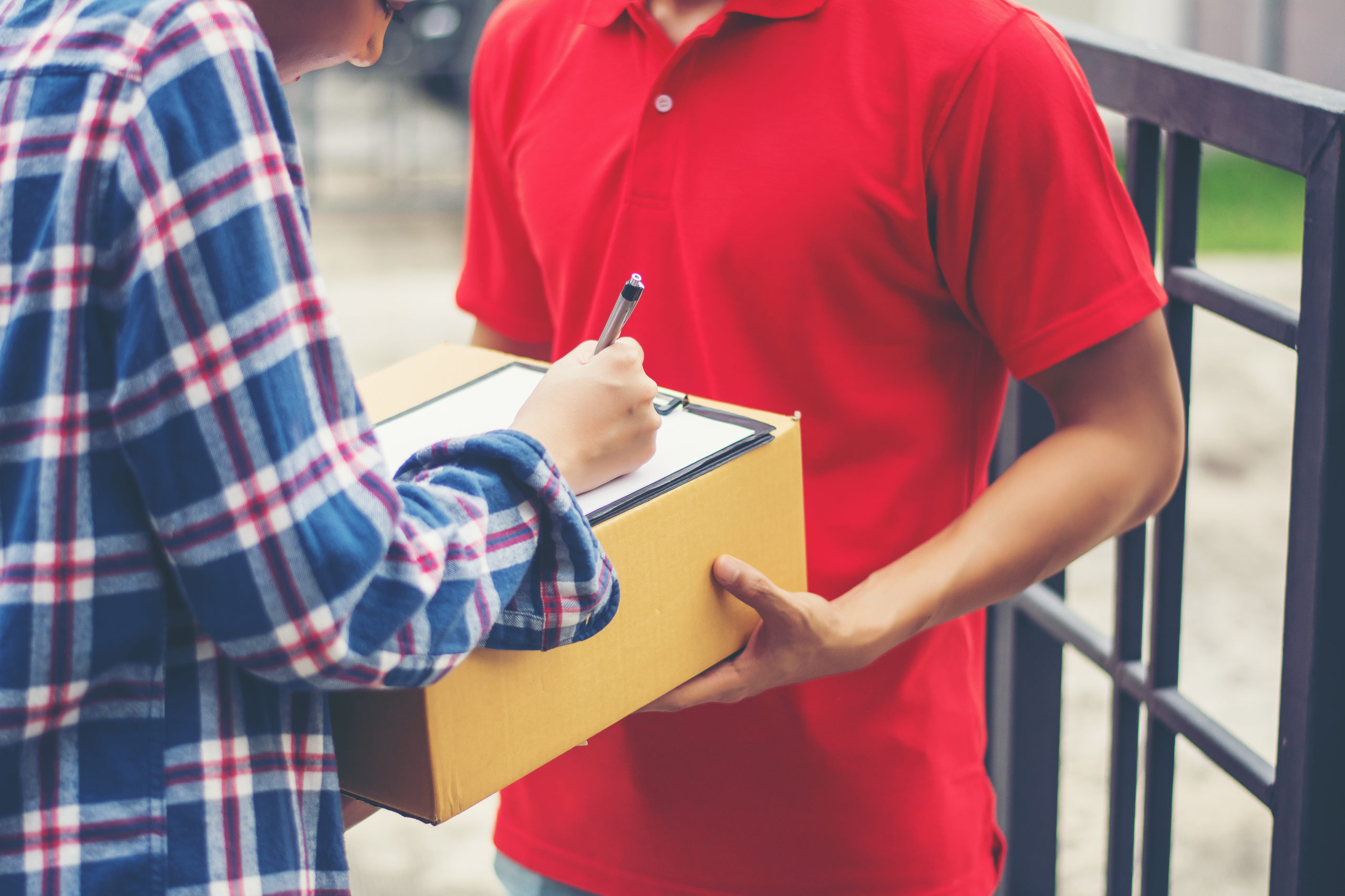Young man Delivering Package to customer at home. Delivery
